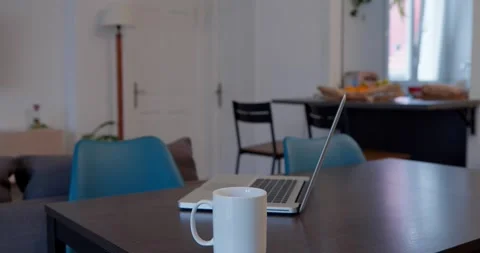 A peaceful setting with a laptop and a mug of coffee on a table. Stock Footage 334651575