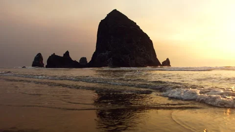 Peaceful shot of the waves at Haystack Rock in Cannon Beach during Sunset. Stock Footage 246450341
