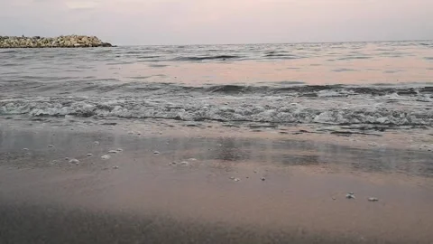 The peaceful sound of the waves and the reflection of the sun Stock Footage 130910543