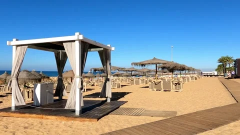 Peaceful Summer Day at an Empty Beachfront Massage Tent in Monte Gordo, Portugal Stock Footage 284768048