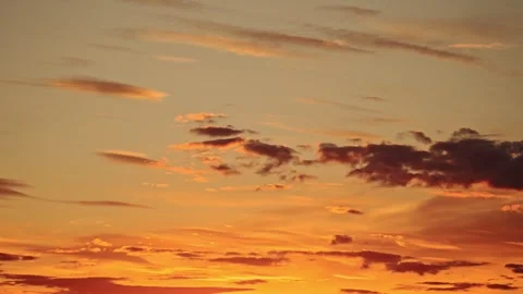 Peaceful sunset sky, slow motion clouds drifting, evoking a calm and romantic Stock Footage 298234129