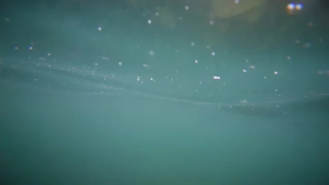 Peaceful underwater view looking up toward the water surface with soft sunlight Stock Footage 337080152