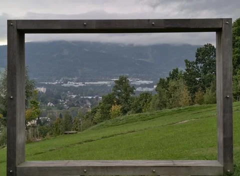 Peaceful valley with distant settlements, serene alpine scenery with layered Stock Photos