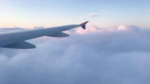 A peaceful view from an airplane window with clouds Stock Footage 313278197