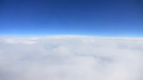 A peaceful view of clouds seen from above with a clear blue sky in the back.. Stock Footage 286199021