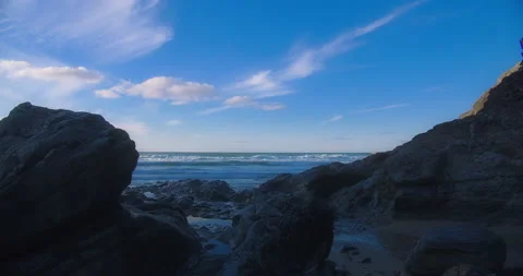 Peaceful view of ocean waves through stones on beach, parallax Stock Footage 151523399