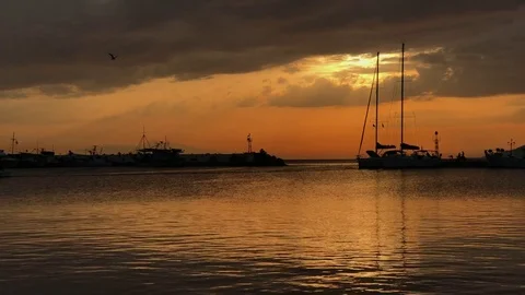 Peaceful view on small harbour with many parked boats at sunset in Greece 库存影片 80484006