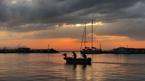 Peaceful view on small harbour with many parked boats at sunset in Greece Video stock 80484422