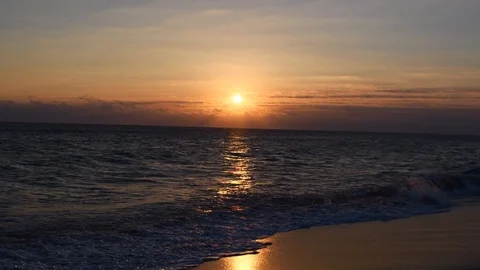 Peaceful waves rolling on the beach at sunrise Stock Footage 108642459