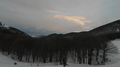 Peaceful winter mountains landscape with dramatic clouds at dusk Stock Footage 328369525