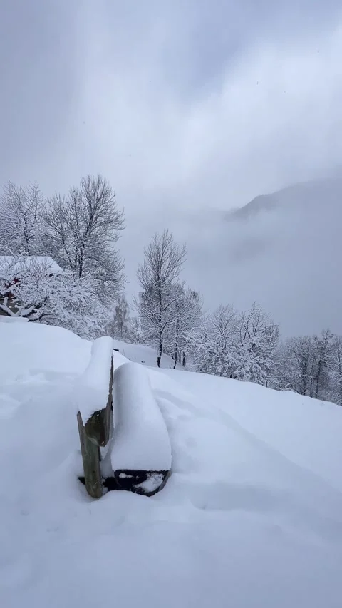 Peaceful winter scenery with a bench under snow in French alps, France Stock Footage 334412253