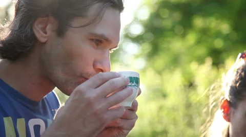 Peaceful young man drinking tea at picnic Video stock 51449170