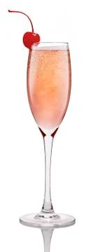 Peach champagne with a cherry on the side Stock Photos