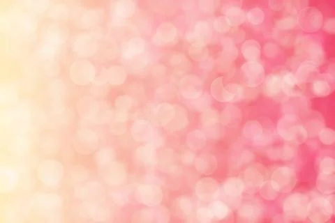 Peach colored background with circle shaped bokeh. Pink to beige gradient. 库存照片