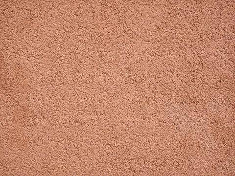 Peach colored rough wall texture 写真素材