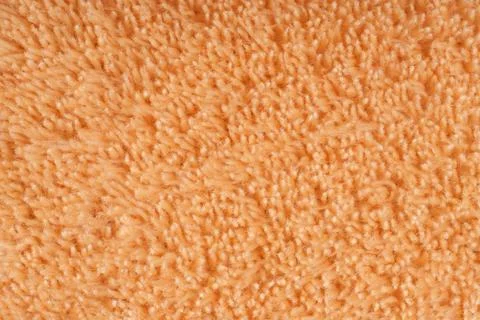 Peach colored texture of soft fluffy fleece with long pile Stock Photos