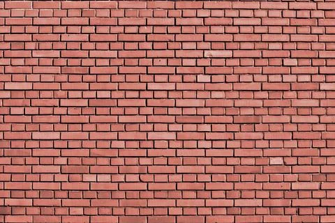 Peach echo colored brick wall background Stock Photos
