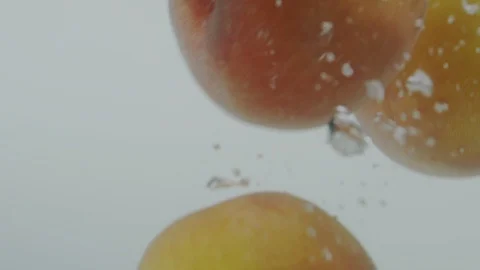Peach falling in water Stock Footage 98299923