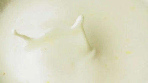 Peach falling to yogurt full hd slow motion close up video. Fruit drop splash Stock Footage 83937411