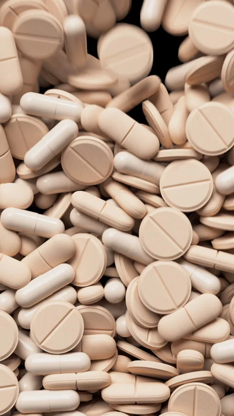 Peach fuzz tablets fall and fill the screen . Drugs, pills, tablets, medicine Video stock 323122495
