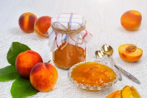 Peach jam in the jar on the table Stock Photos