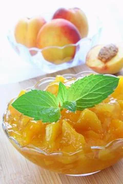 Peach jam with mint leaves Stock Photos