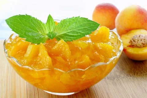 Peach jam with mint leaves Stock Photos