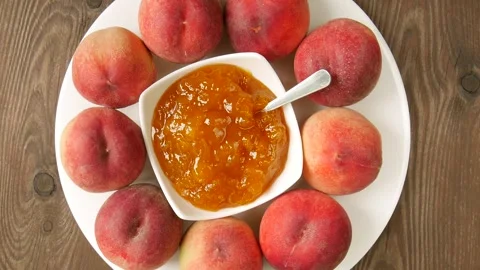 Peach jam on a plate. Video stock 296879335