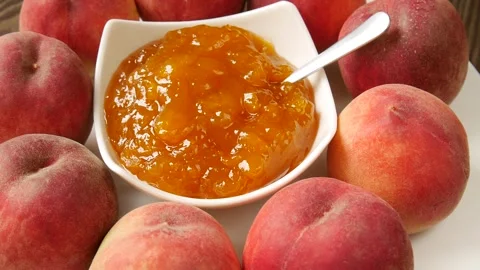 Peach jam on a plate. 스톡 동영상 297185098