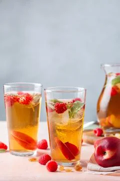 Peach raspberry iced tea, summer refreshing drink, beverage, cocktail Stock Photos