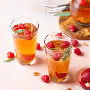 Peach raspberry iced tea, summer refreshing drink, beverage, cocktail Stock Photos