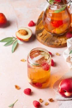 Peach raspberry iced tea, summer refreshing drink, beverage, cocktail Stock Photos