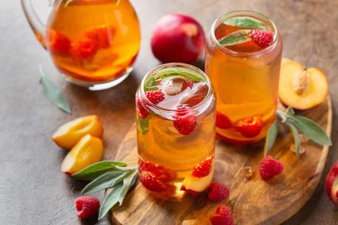 Peach raspberry iced tea, summer refreshing drink, beverage, cocktail Stock Photos