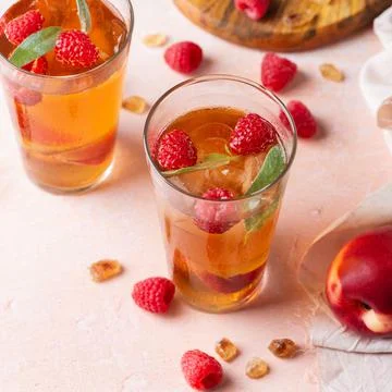 Peach raspberry iced tea, summer refreshing drink, beverage, cocktail Stock Photos