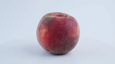 Peach rotates on white background, showing fresh fruit with natural texture. 4k Vídeos de archivo 342963965