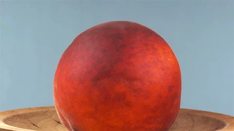 Peach on a rotating plate. Stock Footage 138294914
