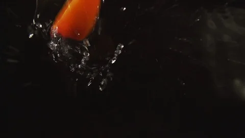 Peach slices fall into the water Stock Footage 95980539