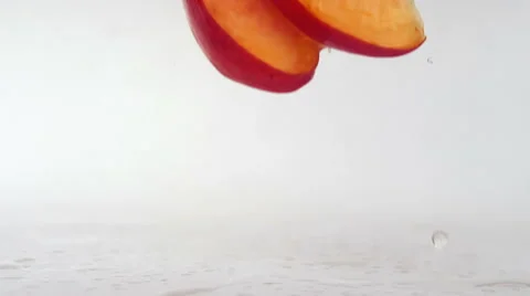 Peach slices falling on a wet surface Stock Footage 59105218