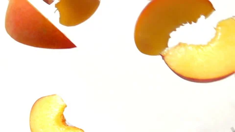 Peach slices fly close-up on a white background Stock Footage 104628152