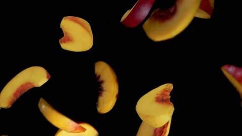 Peach slices fly down on a black background Stock Footage 117931466