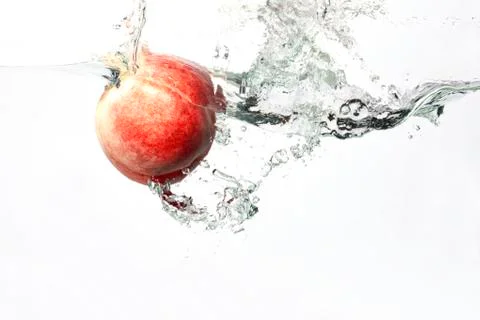 Peach Splashing in Water Stock Photos