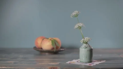 Peach in a vase and in a ceramic dish Stock Footage 344346024