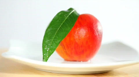 Peach on white plate Stock Footage 828024