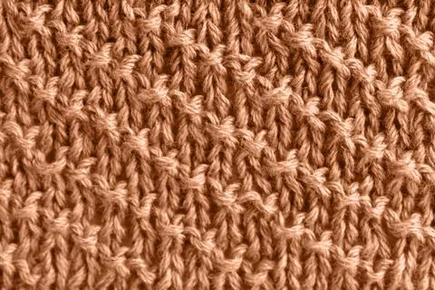 Peach wool knit with diagonal stripes. Color of the year 2024 Stock Photos