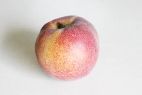 Peaches lying on the table on a white background Stock Photos