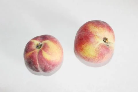 Peaches lying on the table on a white background Stock Photos