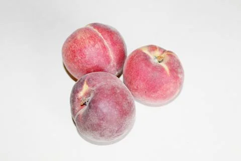 Peaches lying on the table on a white background Stock Photos