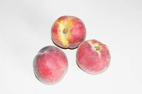 Peaches lying on the table on a white background Stock Photos