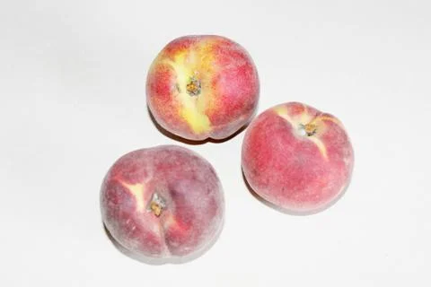 Peaches lying on the table on a white background Stock Photos