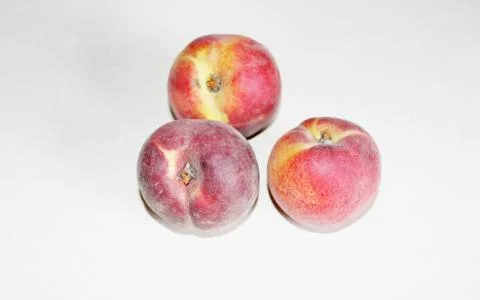 Peaches lying on the table on a white background Stock Photos